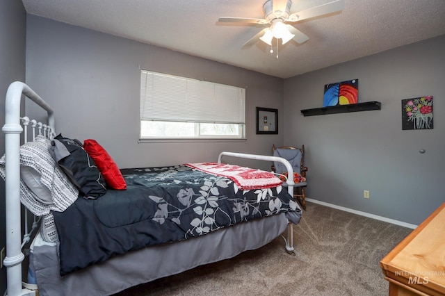 carpeted bedroom featuring a textured ceiling, baseboards, and a ceiling fan