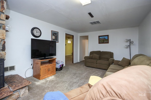 carpeted living area featuring visible vents and a fireplace