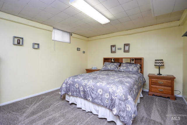 bedroom featuring baseboards and carpet flooring