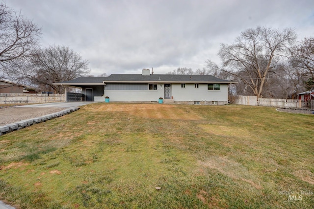 single story home featuring an attached carport, fence, and a front lawn