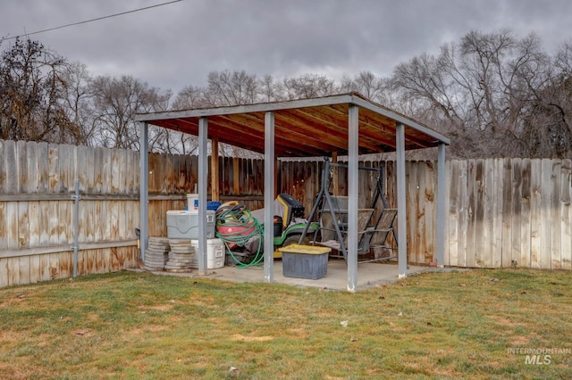 exterior space with an outdoor structure, a fenced backyard, and a pole building