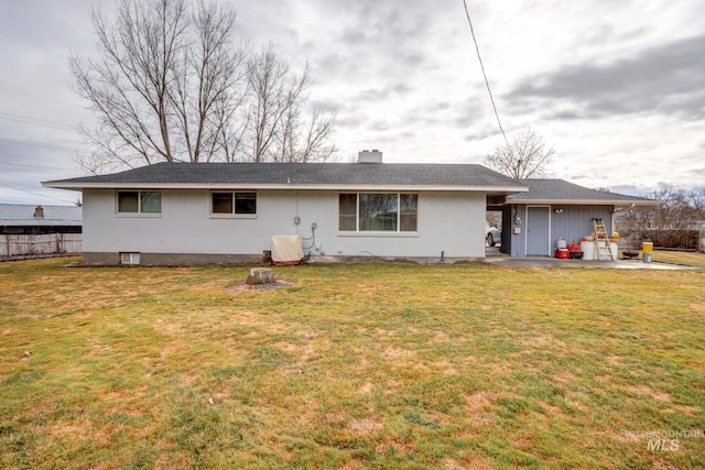 back of house featuring a lawn, a patio, fence, brick siding, and a chimney