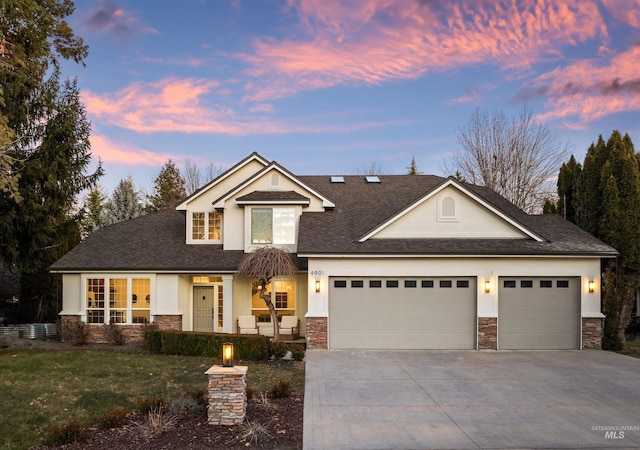 view of front of property featuring a garage and a lawn