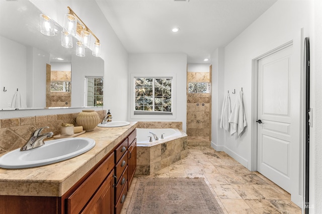 bathroom with vanity and independent shower and bath