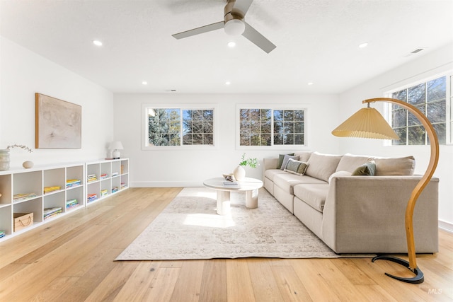 living room featuring ceiling fan and light wood-type flooring