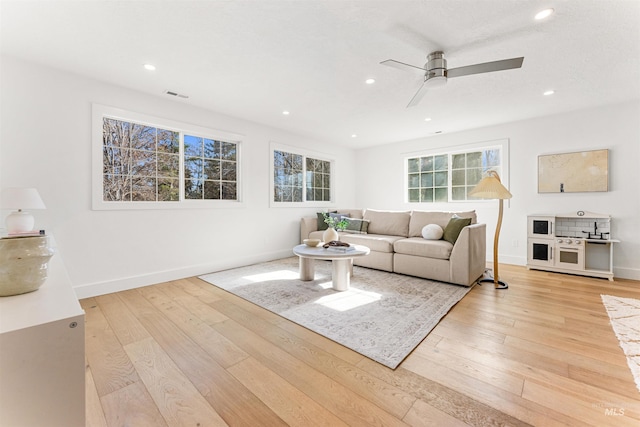 living room with ceiling fan and light wood-type flooring