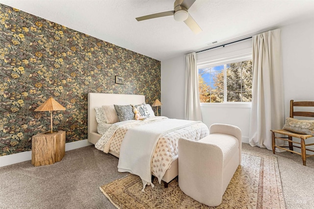 bedroom with ceiling fan, carpet floors, and a textured ceiling