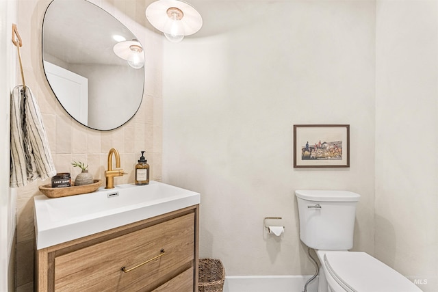 bathroom with tasteful backsplash, vanity, and toilet