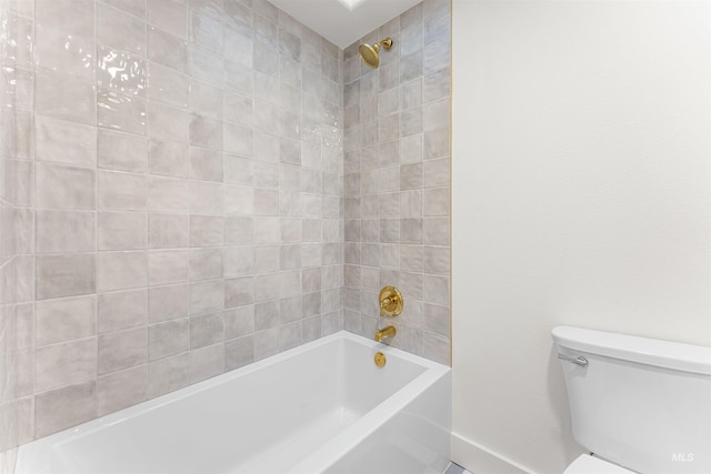 bathroom with tiled shower / bath combo and toilet