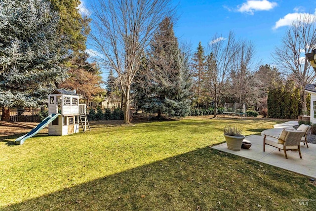 view of yard with a trampoline, a patio area, and a playground