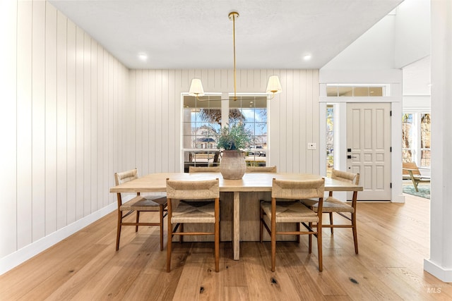 dining space with light hardwood / wood-style flooring