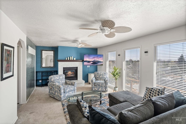 398 N Pebble Beach Way, Eagle, ID 83616 - living area featuring light carpet, a ceiling fan, a textured ceiling, a fireplace, and baseboards