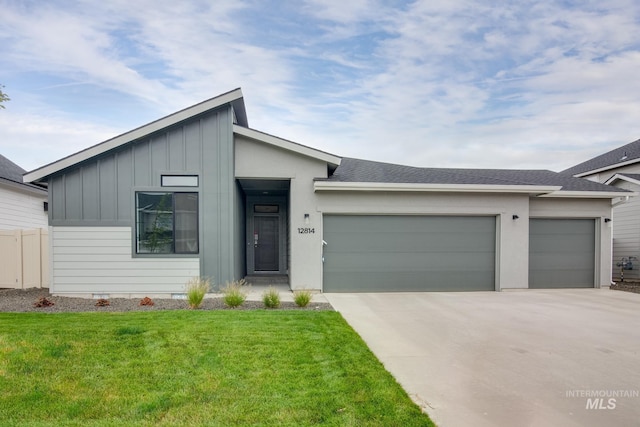 view of front of home with a garage and a front lawn