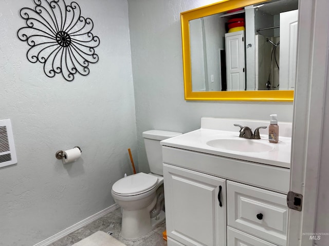 bathroom featuring tile patterned floors, vanity, and toilet