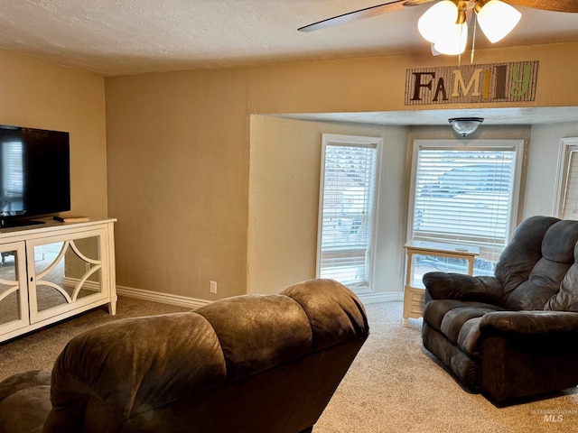 living room with carpet flooring, a textured ceiling, and ceiling fan