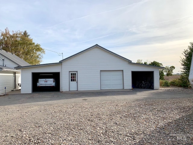 view of garage at dusk