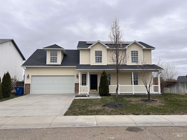 view of front of property featuring concrete driveway, a front lawn, a porch, solar panels, and a garage