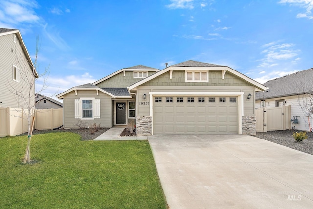 view of front of home with concrete driveway, a front lawn, fence, and a gate