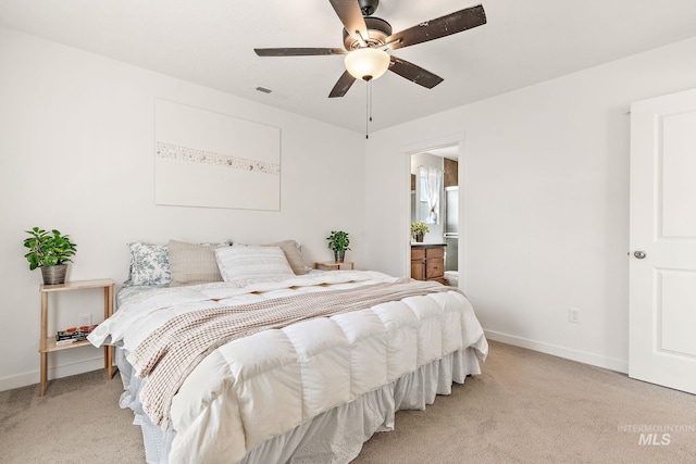 bedroom with visible vents, a ceiling fan, light carpet, connected bathroom, and baseboards