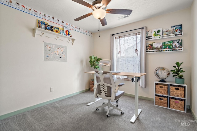 office area featuring a textured ceiling, carpet floors, a ceiling fan, visible vents, and baseboards