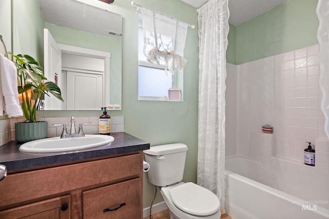 bathroom with visible vents, shower / tub combo with curtain, vanity, and toilet