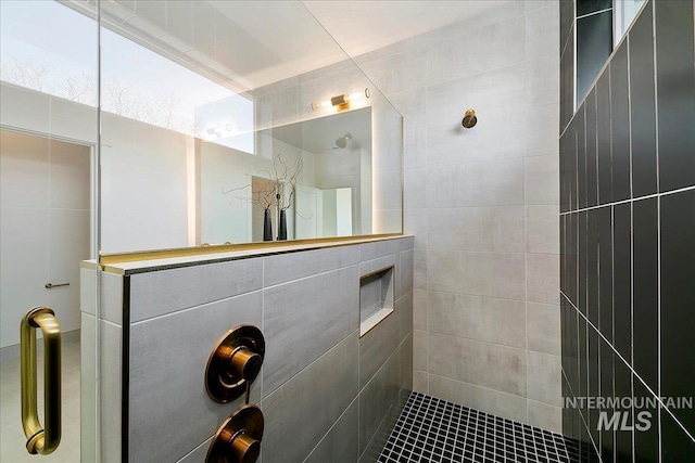 bathroom with a tile shower