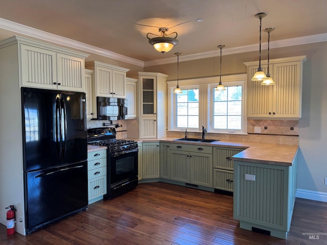 kitchen with dark wood-type flooring, crown molding, a sink, and black appliances