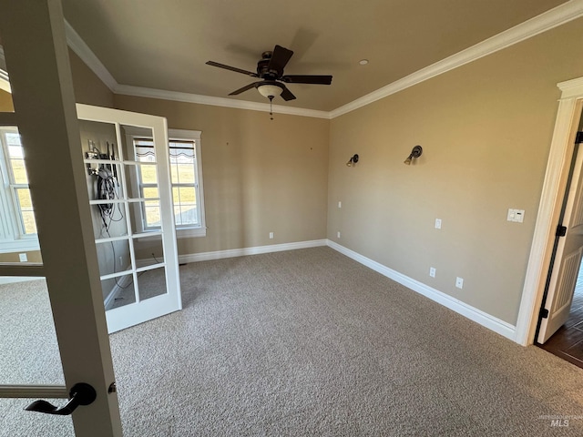 spare room with crown molding, baseboards, ceiling fan, and carpet flooring