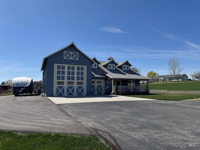 831 W Central Rd, Emmett, ID 83617 - view of front facade with a porch, an attached garage, an outdoor structure, a front lawn, and driveway