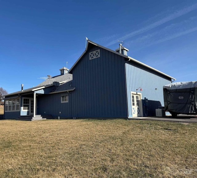 back of property featuring cooling unit, a yard, and entry steps