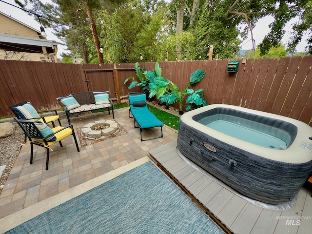 1639 E Boise Ave, Boise, ID 83706 - fenced backyard featuring an outdoor fire pit, a hot tub, and a patio