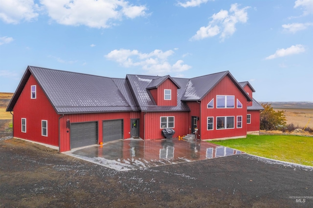 view of front of home with a front yard and a garage