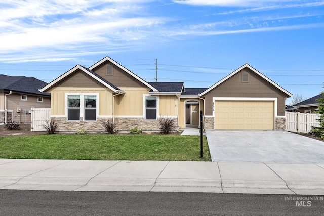 1734 Shoal Point Ave, Middleton, ID 83644 - craftsman-style house with concrete driveway, stone siding, a front yard, a garage, and fence