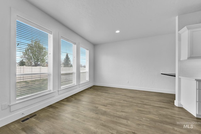 1734 Shoal Point Ave, Middleton, ID 83644 - unfurnished living room featuring visible vents, baseboards, recessed lighting, and wood finished floors