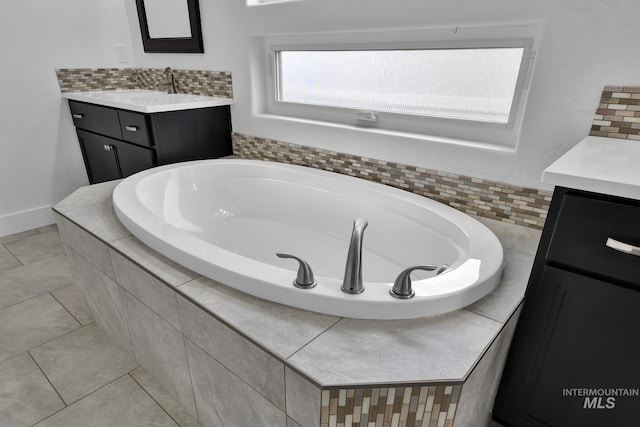 1734 Shoal Point Ave, Middleton, ID 83644 - full bath featuring a garden tub, vanity, backsplash, and tile patterned flooring