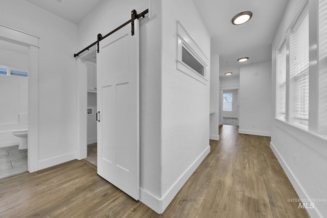 1734 Shoal Point Ave, Middleton, ID 83644 - hallway with baseboards, a barn door, and wood finished floors