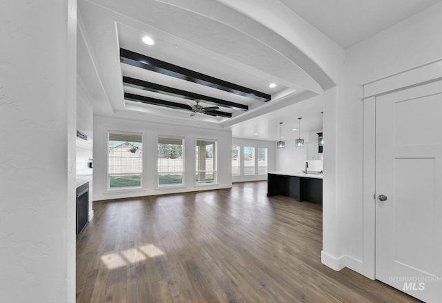 1734 Shoal Point Ave, Middleton, ID 83644 - unfurnished living room featuring arched walkways, ceiling fan, dark wood finished floors, a fireplace, and recessed lighting