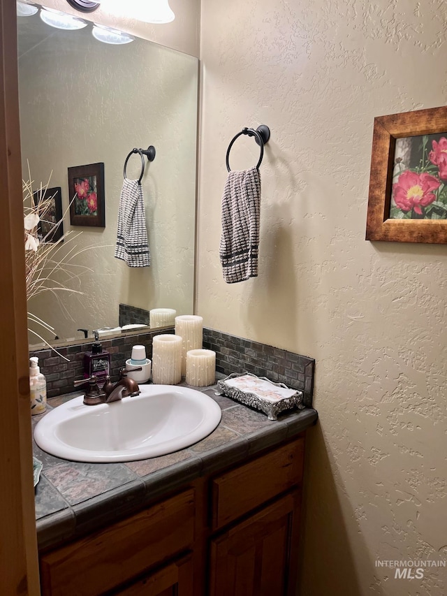 bathroom featuring decorative backsplash and vanity