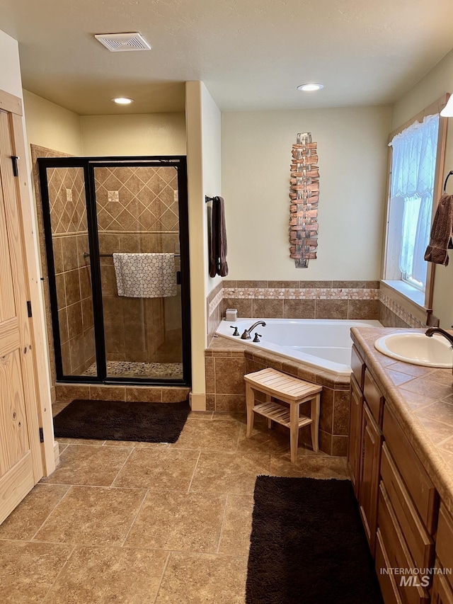 bathroom featuring tile patterned flooring, vanity, and independent shower and bath