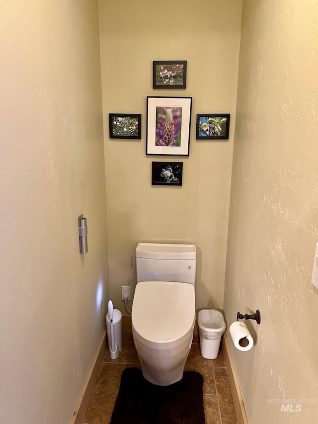 bathroom with tile patterned flooring and toilet