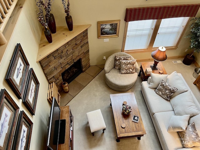 living room with a stone fireplace