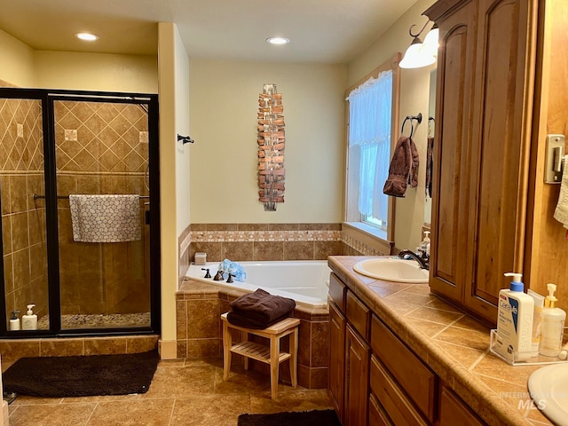 bathroom with tile patterned flooring, vanity, and independent shower and bath