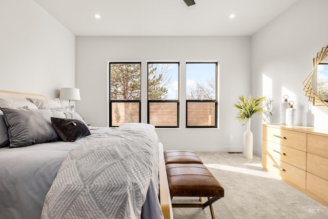 bedroom with light carpet and ceiling fan