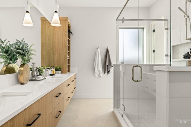 bathroom with a shower with door and vanity