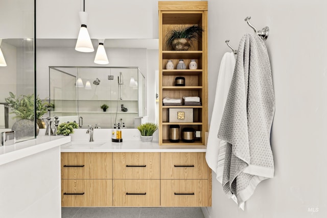 bar with pendant lighting, light brown cabinets, and sink