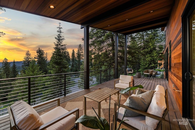 1678 Majestic View Dr, Mccall, ID 83638 - deck at dusk with an outdoor living space and view of scattered trees