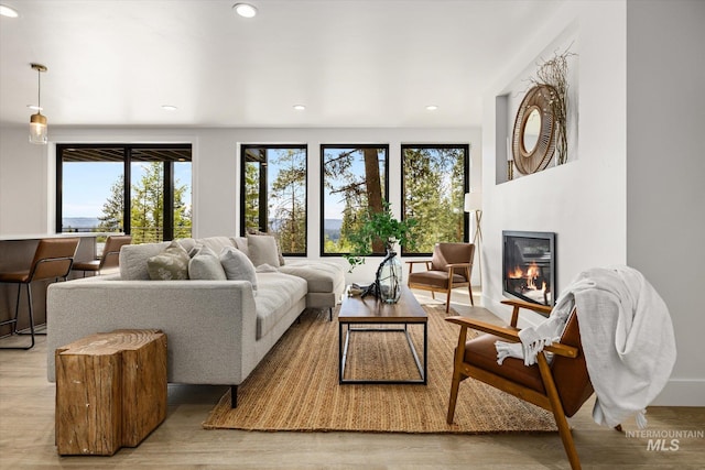 1678 Majestic View Dr, Mccall, ID 83638 - living room with a glass covered fireplace, light wood-style floors, and recessed lighting
