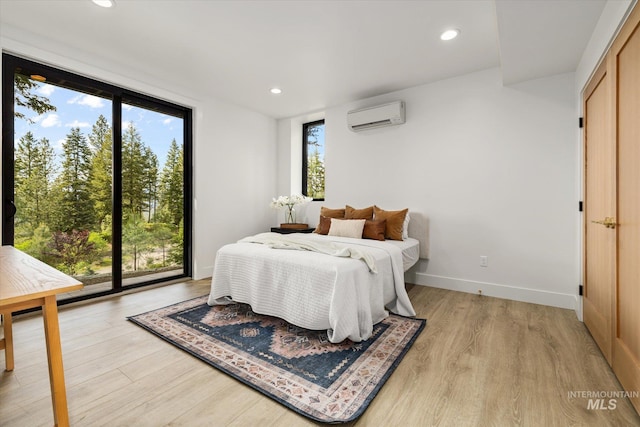 1678 Majestic View Dr, Mccall, ID 83638 - bedroom with a wall mounted AC, light wood-style floors, and recessed lighting