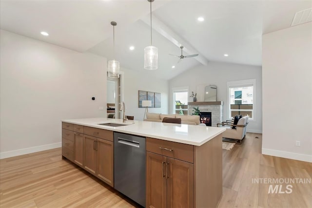 6874 N Fireball, Meridian, ID 83646 - kitchen featuring dishwasher, a sink, a fireplace, light wood-style flooring, and light countertops