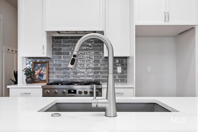 6874 N Fireball, Meridian, ID 83646 - kitchen featuring light countertops, white cabinets, and decorative backsplash